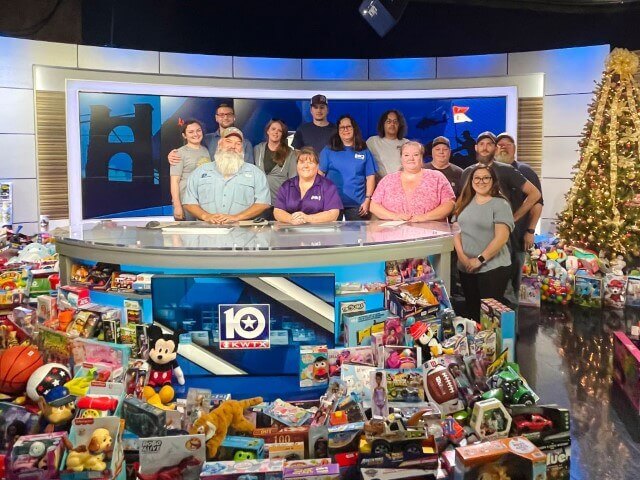 HSC staff at the news station after bringing trucks full of toys collected for Toys for Tots