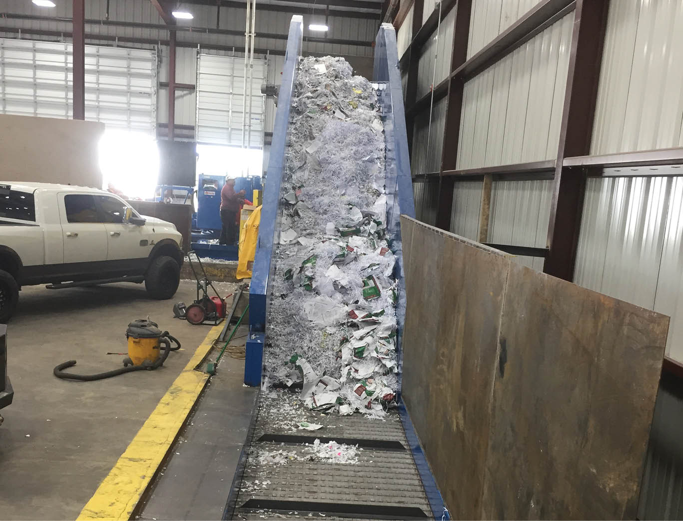 Infeed conveyor moving paper after conveyor and baler installation