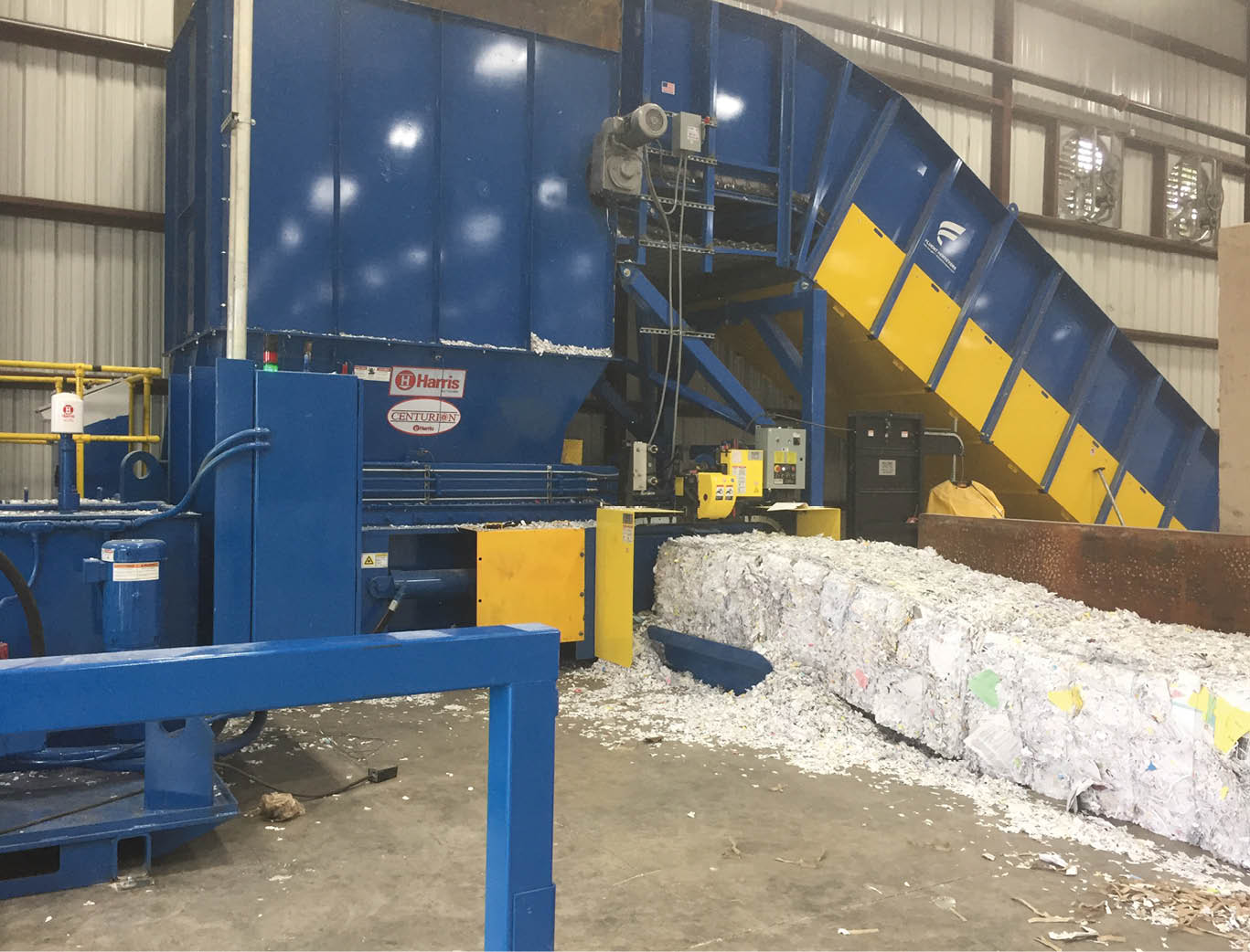 Newly installed Harris Centurion two-ram baler and Fluent conveyor making paper bales